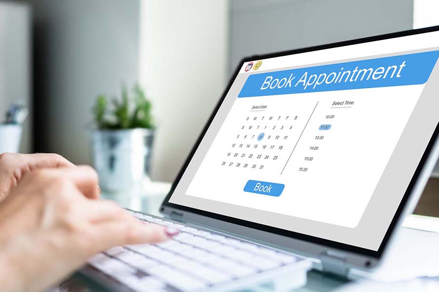 Scheduling And Booking Online Appointment In Calendar Using Laptop